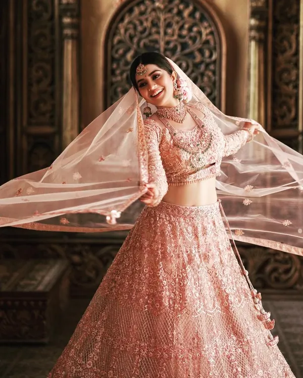 This is what dream wedding lehengas are made of. I designed this blush pink creation for the beautiful actress Megha Shetty, featuring layers of intricate threadwork and a flowing silhouette that feels both royal and romantic.