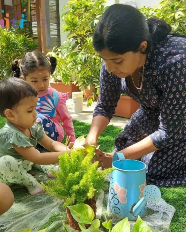 A teacher shows our toddlers how to care for a plant. These gentle introductions to gardening are part of our Exercises of Practical Life.