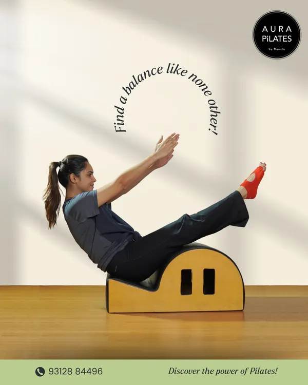 Finding balance is a key principle of Pilates. This image shows a client performing a teaser on the spine corrector, a move that requires immense core control and balance.