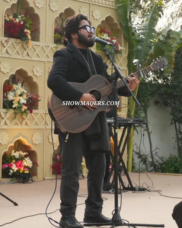 A soulful singer and guitarist performing at the Banaras themed event, providing the perfect musical backdrop.
