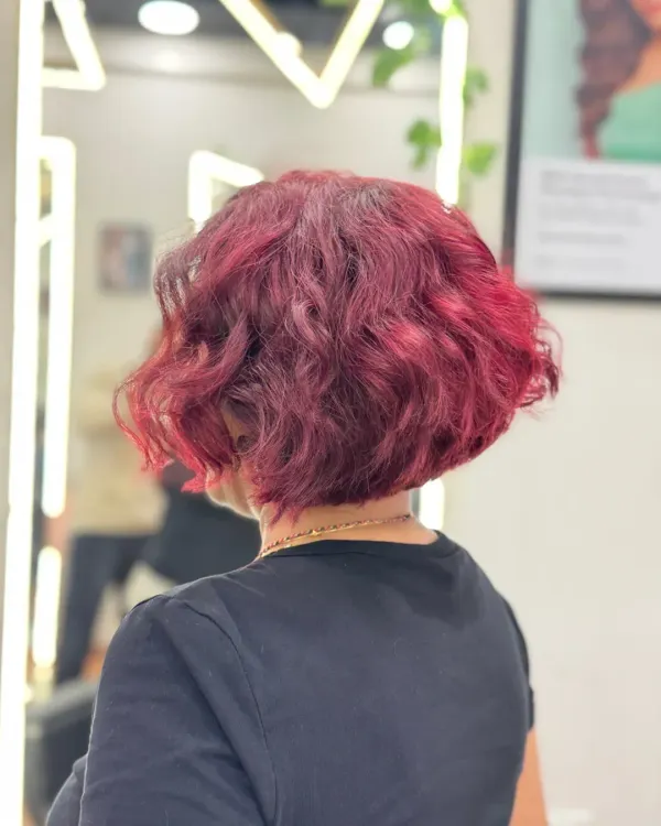 A chic warm wine color on a modern bob cut. This back view shows how the rich, vibrant tones and precision cut work together to create a bold and stylish statement.
