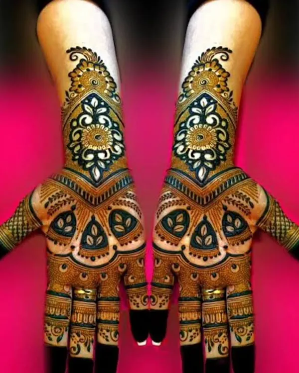 A striking design with bold, symmetrical patterns. The use of dark henna for the outlines and negative space makes the intricate details pop, creating a very modern and graphic look.