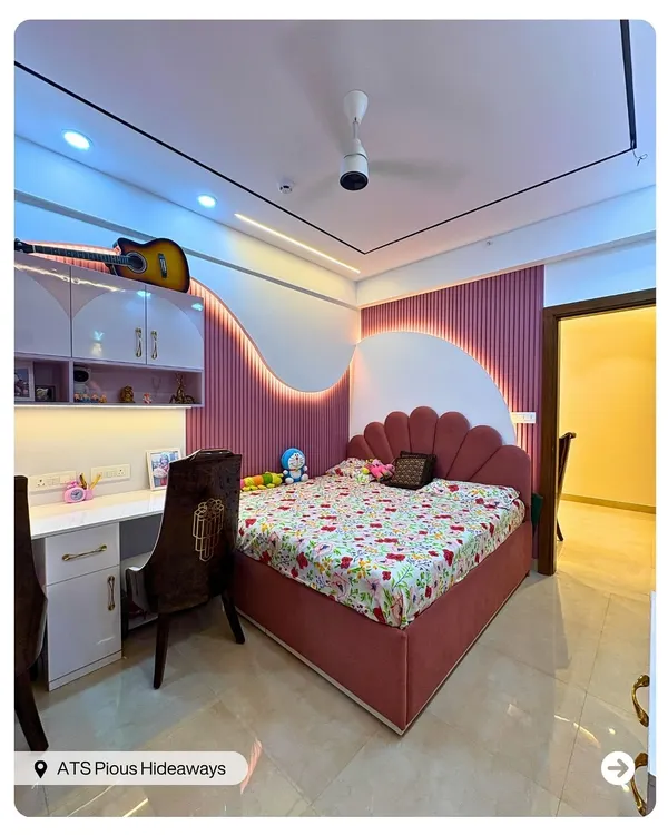 A dream room for a little rockstar. This space features a fun, wavy pink and white accent wall, a shell-shaped headboard, and a guitar displayed proudly on the shelf.