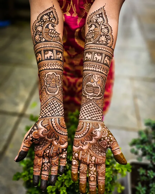 A stunning example of full bridal henna, featuring a dark, fresh application with intricate details like elephants, peacocks, and traditional kalash motifs.