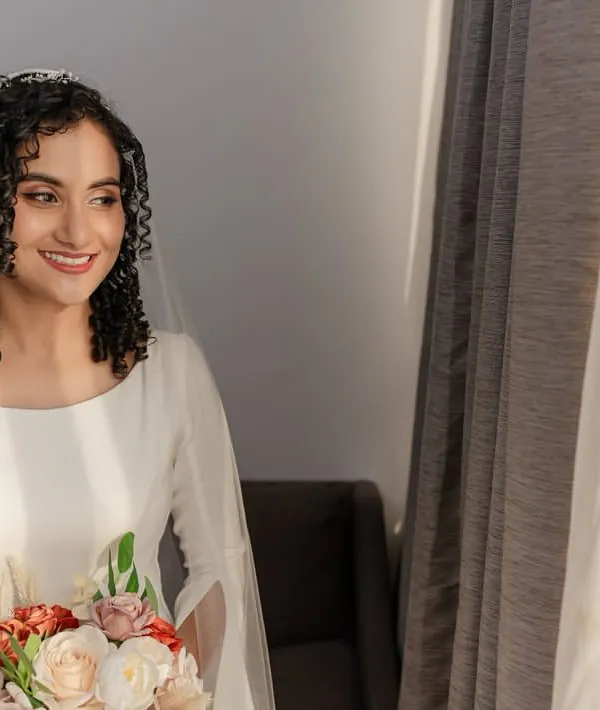 What's better than having your hair naturally styled on your big day? This beautiful bride chose to embrace her curls, and she looks absolutely radiant.