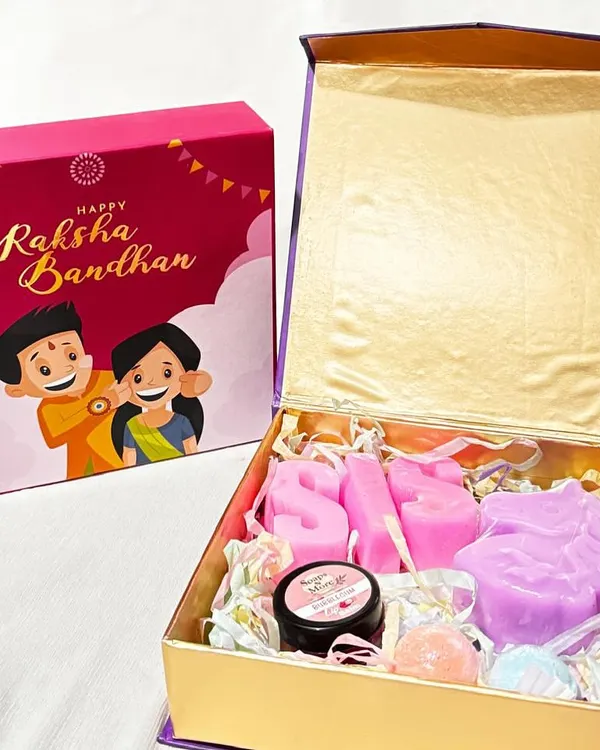 A beautiful Raksha Bandhan hamper for your little sister. This gift box includes 'SIS' letter soaps, a unicorn soap, mini bath bombs, and an organic lip balm, packed in a festive magnet box.