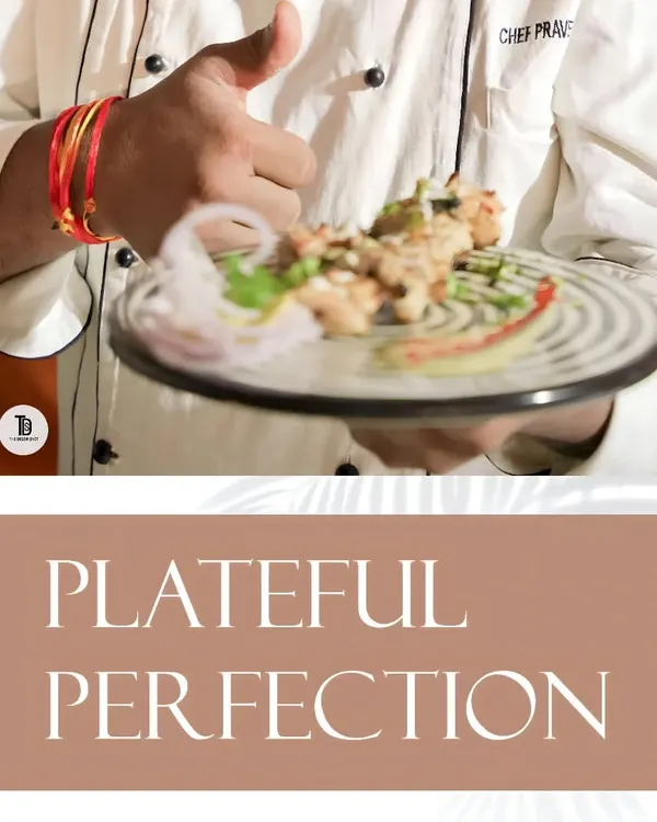 "Plateful Perfection" is our motto. Here, one of our chefs presents a beautifully garnished plate, showcasing the final product of our culinary expertise.