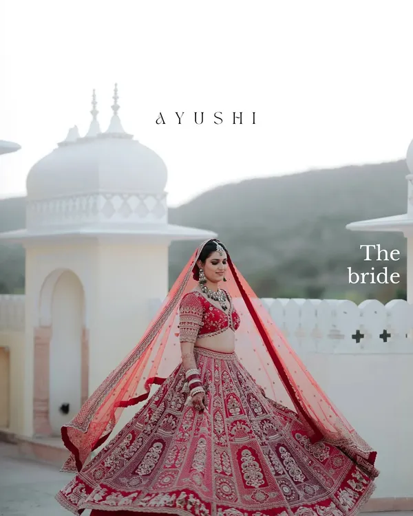 A bride framed against the majestic domes of a Rajasthani palace. We use the grandeur of the location to create breathtaking, wide-angle portraits that feel truly royal.