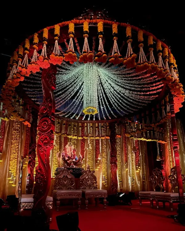 A grand circular mandap I designed for a Ganesh Chaturthi celebration. The canopy is made from countless strings of fresh jasmine and tuberose, with a central floral chandelier.