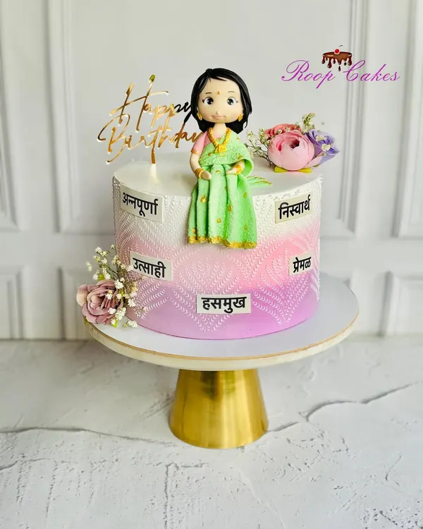 A cake as graceful as she is. This custom birthday cake celebrates the many virtues of a wonderful woman, written in Marathi, with an elegant ombre design and a handcrafted fondant figure in a saree.