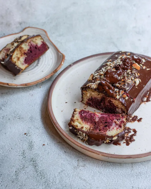 Our new Marble Cake is a classic for a reason. This loaf features swirls of vanilla and rich red velvet cake, all coated in a decadent chocolate glaze and topped with toasted almonds.