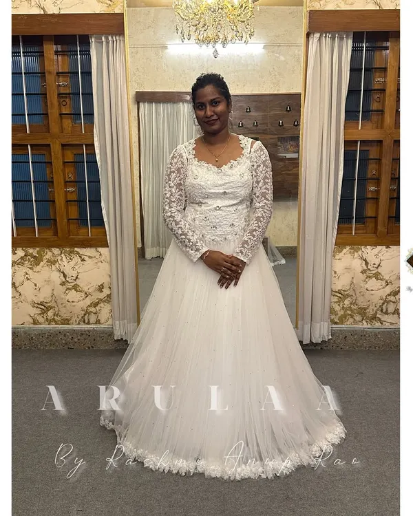 Our gorgeous Mangalore bride in her custom white wedding gown. We designed this elegant piece with a full tulle skirt and a delicate lace bodice and sleeves.