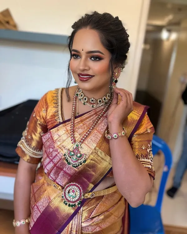 A stunning look for a ring ceremony. This client is wearing a beautiful silk saree, and we paired it with a classic makeup look featuring defined, winged eyeliner, a matte red lip, and a perfectly blended base that looks like second skin.