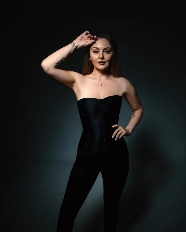 A studio portrait session playing with light and shadow. The black corset and dark background reflect the deep, atmospheric side of my melodic techno productions.