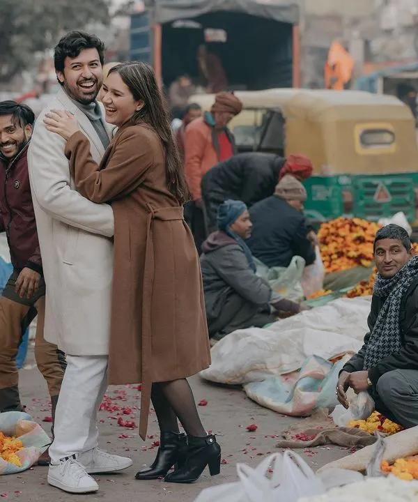 A spontaneous, joyful hug amidst the bustling flower markets of Old Delhi. We thrive on capturing authentic moments of love in real, vibrant environments.