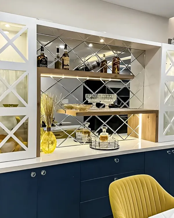 An elegant crockery and bar unit with a striking blue base and white upper cabinets. The diamond-patterned mirror backsplash and integrated lighting add a touch of glamour.
