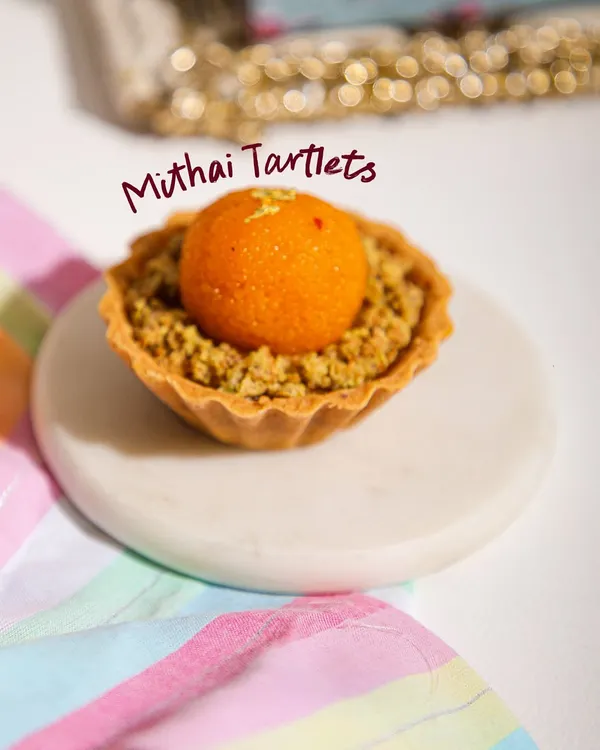 A little twist on tradition. Our Mithai Tartlets, like this Motichoor Ladoo Tart, combine festive Indian flavours with classic patisserie finesse.