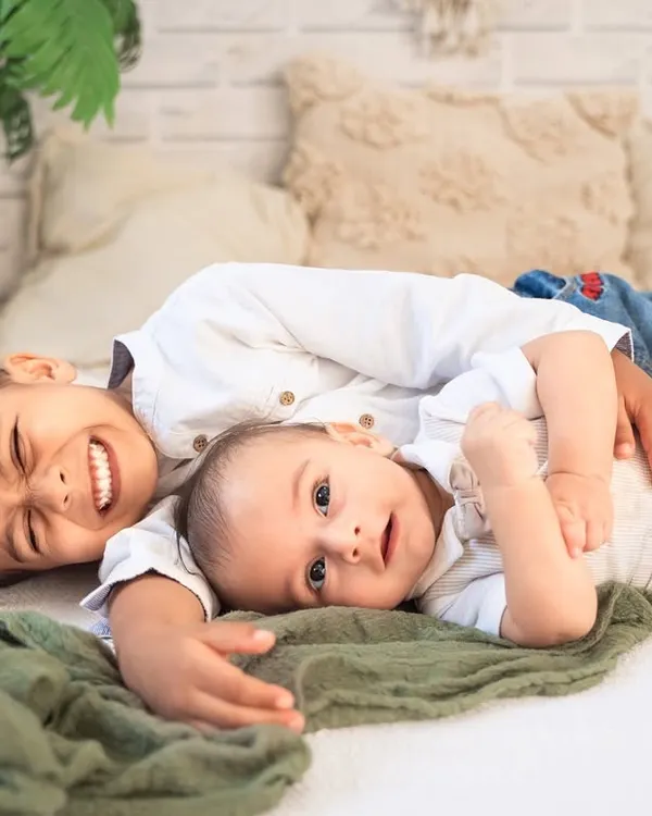 The best of brothers. This photo captures a moment of pure, goofy fun between two siblings during their relaxed, boho-themed studio session.