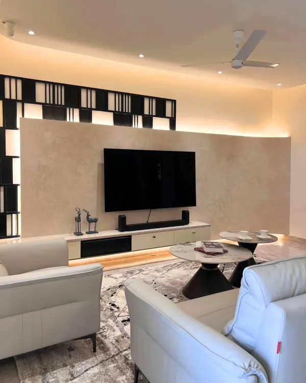 For Harshita and Ankit's living room, I designed this TV wall with a soft, textured finish and a bold geometric frame, adding depth without stealing the spotlight.