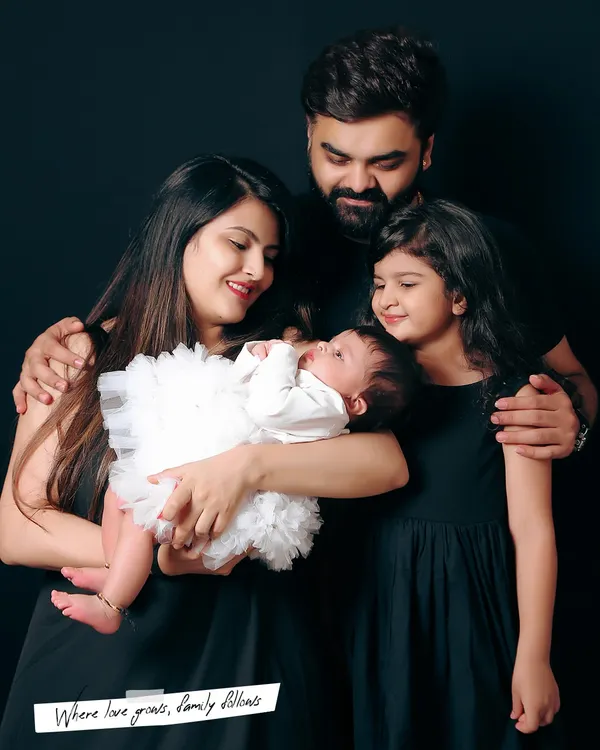 A beautiful family portrait with a mother, father, and two children. I love capturing the connection between everyone, especially the older sister looking lovingly at her new baby sibling.