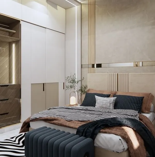 This master bedroom is a sanctuary of minimalist elegance. We used soft neutral tones, luxurious fabrics, and sleek custom cabinetry with gold accents to create a serene and inviting ambiance for relaxation.