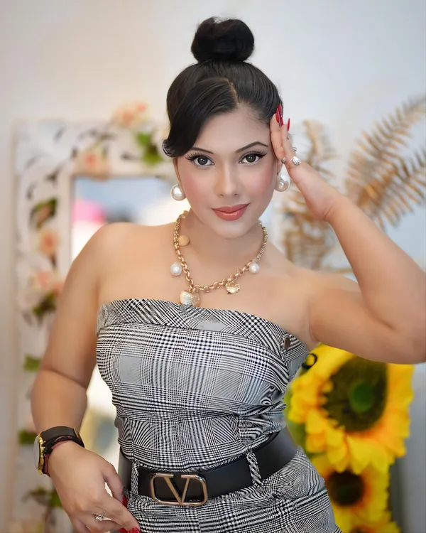 A confident, high-fashion look featuring a plaid tube top and a Valentino belt. This shot is perfect for luxury fashion and accessory brands seeking a model with a sophisticated and elegant presence.
