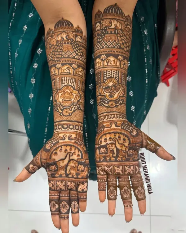 This is a classic Rajasthani bridal design, filled with traditional figures. It includes elephants, peacocks, and palace architecture, with every space filled with intricate patterns.