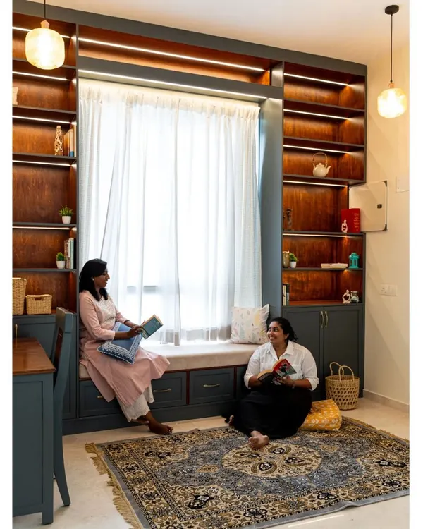 We transformed this staircase landing into a cozy library and reading retreat. The floor-to-ceiling bookshelves are built around a large window, which features a comfortable window seat with integrated drawers for extra storage.