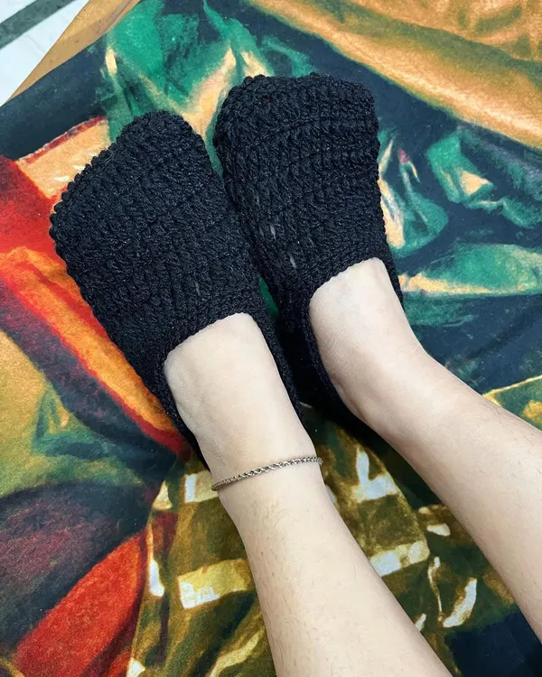 Keep your feet warm with our handmade crochet socks. This is a pair of simple black ankle socks, perfect for wearing around the house.