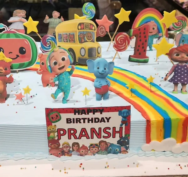 Bring the fun of nursery rhymes to the party with this vibrant Cocomelon sheet cake. It's packed with edible characters, a rainbow road, and colorful details, making it a showstopper for any toddler's first birthday.