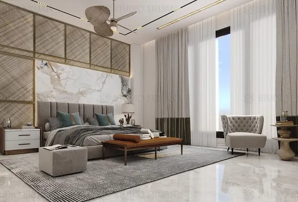 This master bedroom is a sanctuary of style, featuring a stunning headboard wall that combines book-matched marble with brass-inlaid geometric paneling. The floor-to-ceiling windows, dressed in sheer curtains, fill the room with soft, natural light.