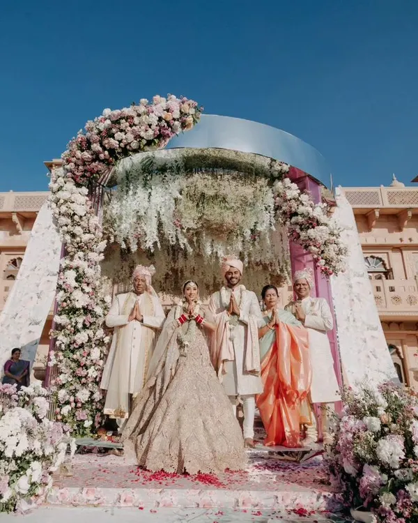 A stunning wide shot of the wedding mandap set against the Welcomhotel Khimsar Fort. This image showcases our ability to capture the scale and grandeur of a royal Rajasthani wedding.