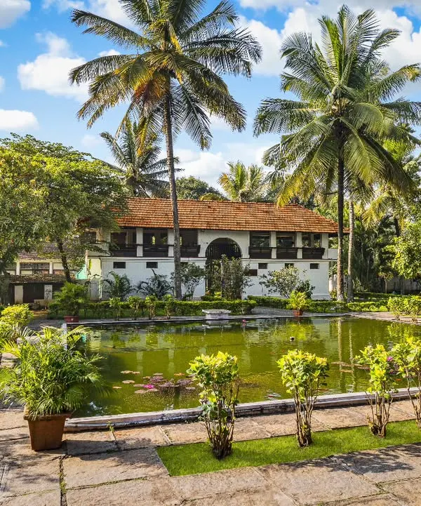 Welcome to Ayurvedagram, where healing feels like coming home. Our center is a tranquil village built from restored heritage Kerala homes, nestled among 13 acres of lush gardens and lotus ponds. This is where your journey to balance and rejuvenation begins.