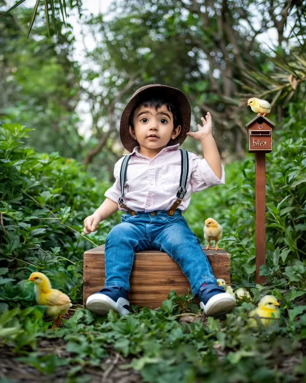 An enchanting outdoor session in a lush garden, complete with cute props like these little chicks.