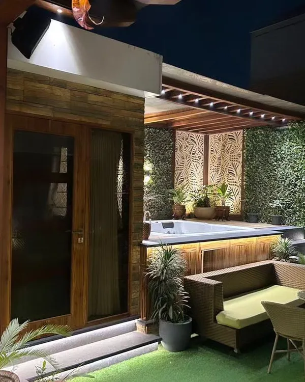 This rooftop is transformed into a private oasis, perfect for unwinding. I designed this space to include a relaxing jacuzzi, a cozy adjoining room, and ambient lighting, all surrounded by lush greenery to create the ultimate escape right at home.