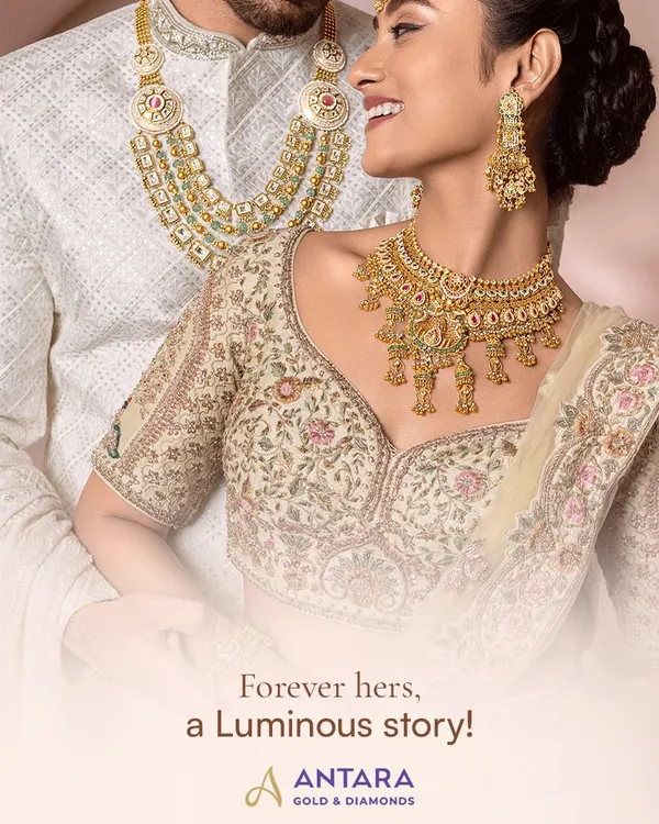 This is the beginning of your luminous story. Here, our bride radiates joy in a sculpted 22kt gold neckpiece with jhumki details, perfectly complemented by the groom's layered gold strings. This is the harmony and elegance I craft for your special day.