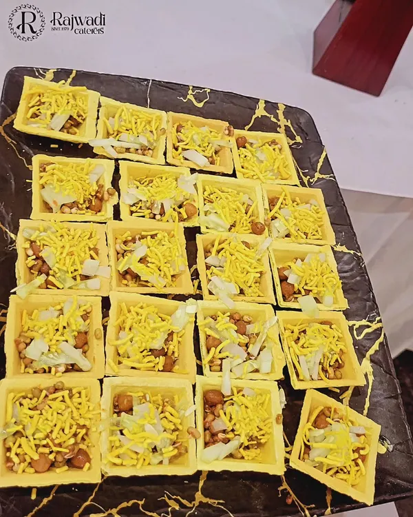 Bite-sized chaat served in edible square canapés. These single-serving appetizers are easy for guests to eat while networking and are a modern twist on a classic snack.