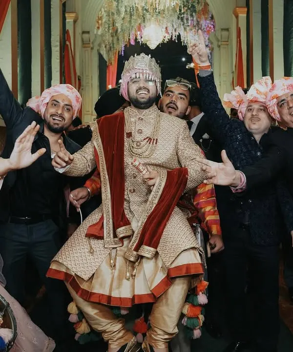 The groom's entry should be full of energy! This shot captures the groom enjoying his baraat, dancing with his friends and family. It's these high-energy, fun-filled candid moments that make a wedding album complete.