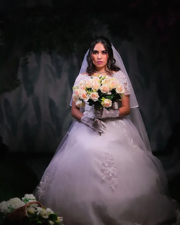A beautiful Christian bride look, complete with a white ball gown, veil, gloves, and a bouquet of roses. I provide complete bridal packages for all cultures.
