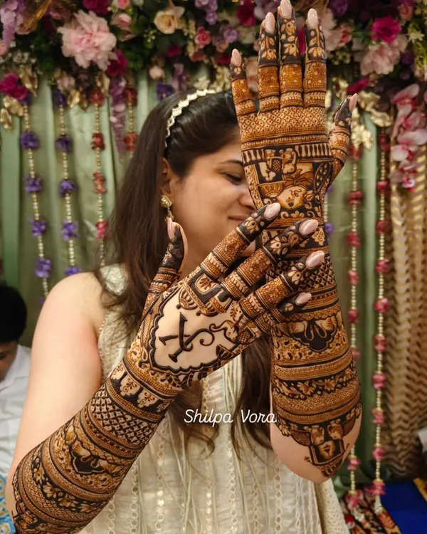A stunning example of a full bridal design. Notice the personalized initial 'K' on the palm, a popular customization I teach students how to incorporate elegantly.