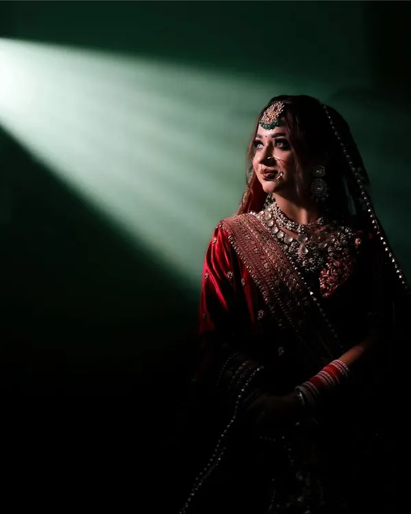I love playing with light to create something truly magical. This dramatic bridal portrait uses a single beam of light to highlight the bride's anticipation and elegance just moments before her ceremony.