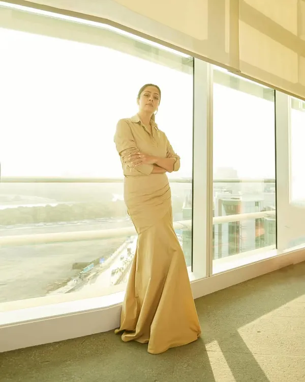 Jyotika in a sophisticated beige shirt-dress, a perfect example of understated elegance for a promotional event.