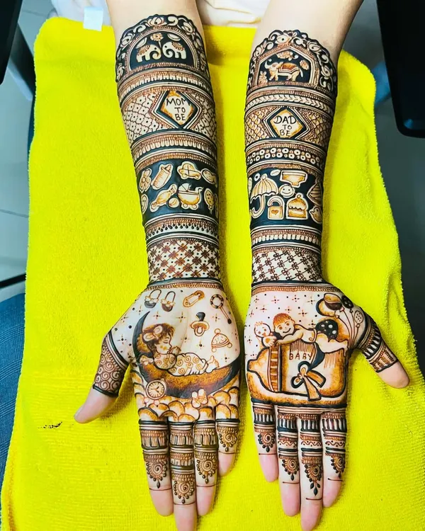Our signature baby shower design. This full-arm mehndi tells a story with a baby on the moon, a cradle, toys, and "Mom" and "Dad" monograms.