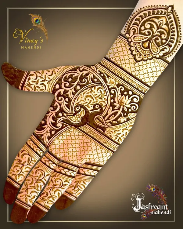 A beautiful back-of-hand design featuring a peacock as the central motif, surrounded by delicate floral vines and traditional jaal work.