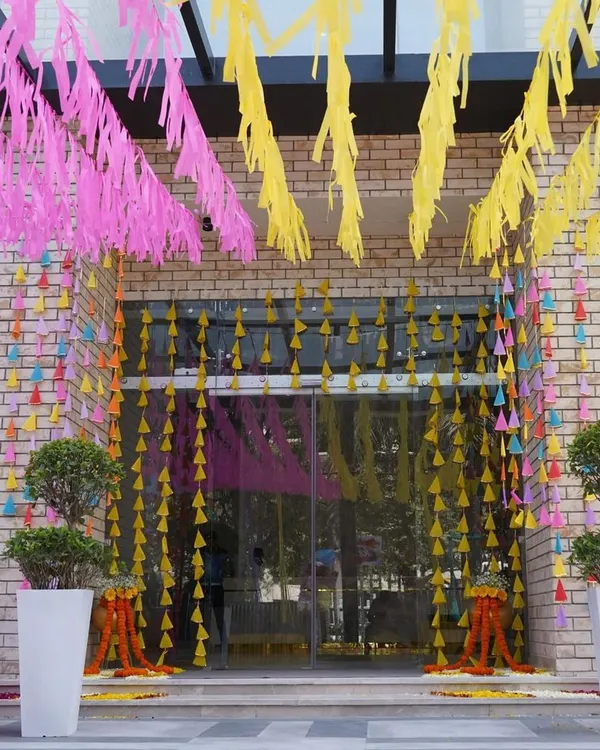 First impressions matter. I created this joyful and colorful entrance using bright paper streamers and hanging tassels to set a festive tone for a corporate Holi party right from the moment guests arrived.