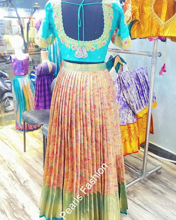 This vibrant lehenga set was created from a single floral saree. I used the body for the pleated skirt and designed a custom embroidered blouse to match.