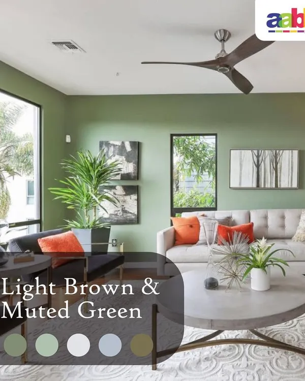 A bright and airy living room featuring a muted green accent wall that complements the natural light and wooden furniture. This is a great example of how we use colour to create a calm and inviting atmosphere in residential spaces.