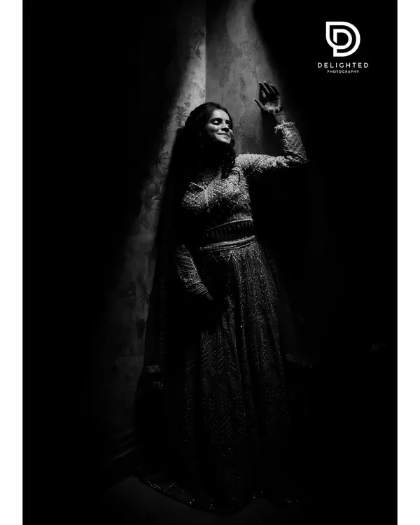 A dramatic black and white bridal portrait using a single sliver of light. This low-key photography technique creates a moody, artistic, and timeless image.