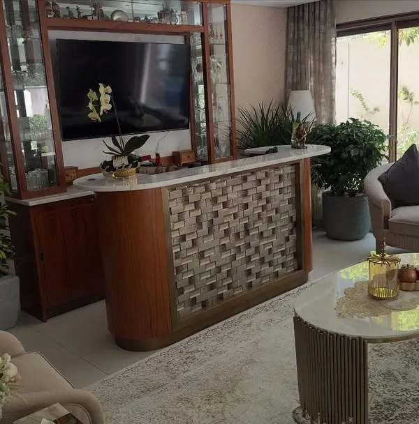 Plants can soften and elevate modern interiors. In this living room, I placed several large potted plants to complement the furniture and add life to the space, including one by the large window to connect with the outside.