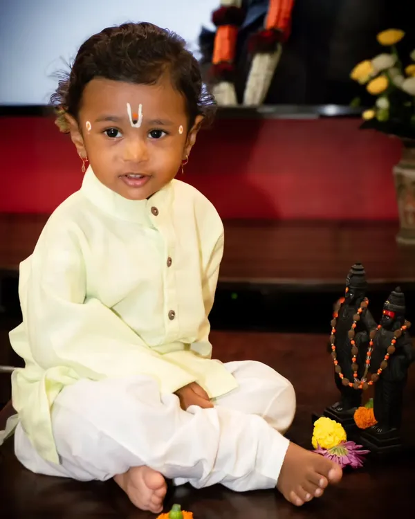Themed shoots are a wonderful way to celebrate culture. Here, a young boy is dressed as a 'Varkari' for Ashadi Ekadashi, sitting beside a small idol of Lord Vithoba.